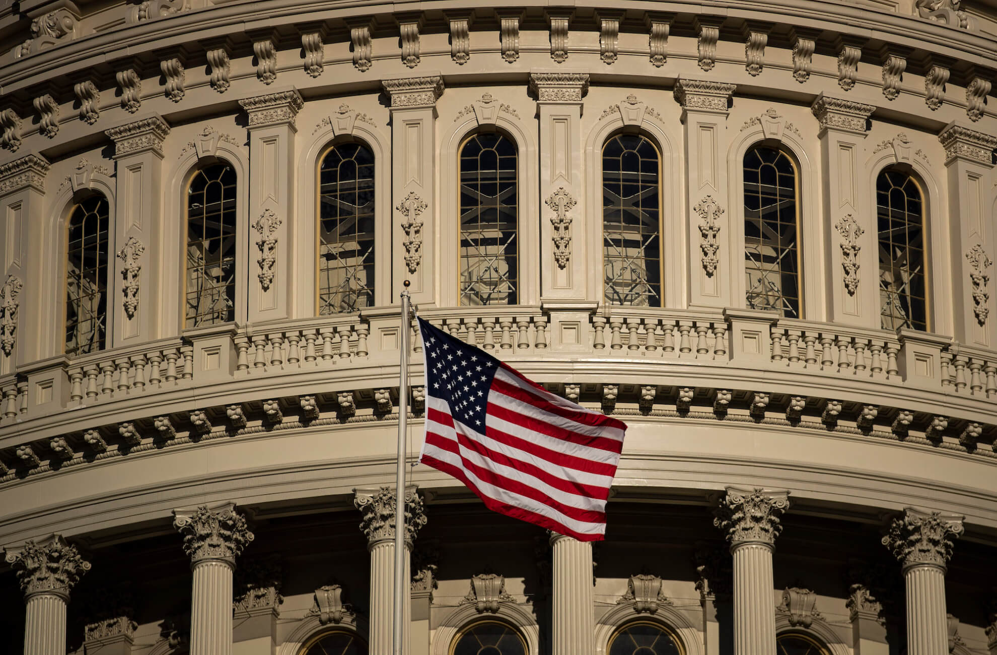 An American flag in front of the U.S. Capitol
