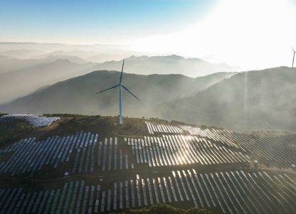 Solar panels and wind turbines on a hill